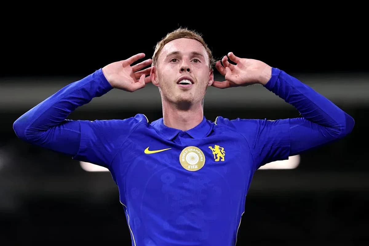 Player celebrating with hands behind ears in blue kit Player celebrating with hands behind ears in blue kit