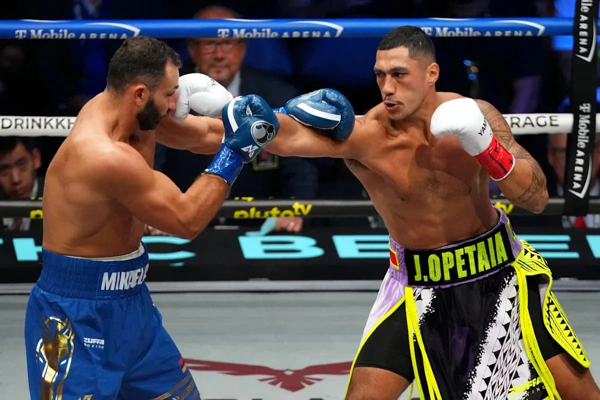 Boxers J. Opetia and M. Mikadze exchanging punches Boxers J. Opetia and M. Mikadze exchanging punches