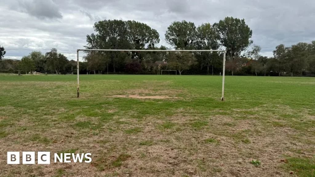 Empty football goal on grassy field Empty football goal on grassy field