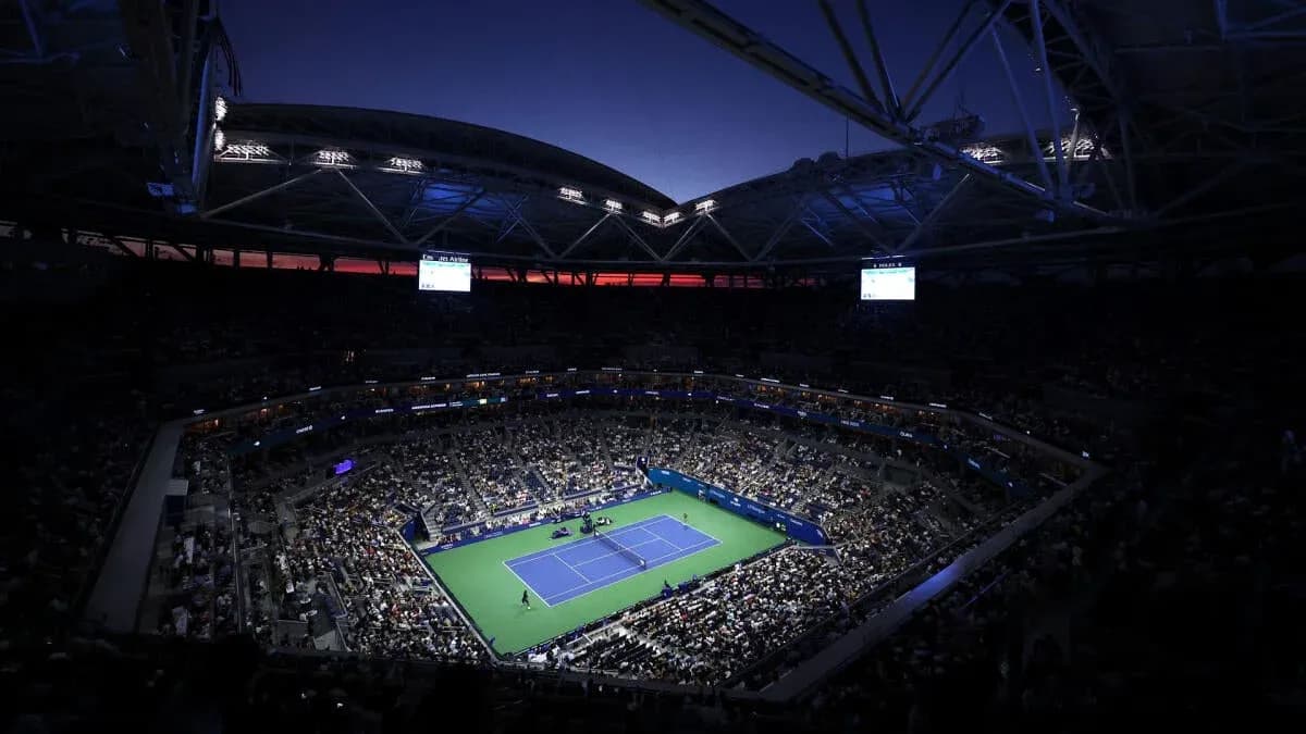 Night match at a packed tennis stadium Night match at a packed tennis stadium