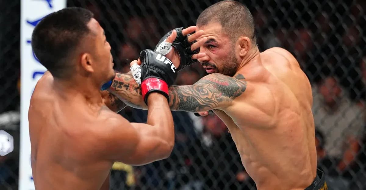 Two fighters engaged in a striking exchange in octagon Two fighters engaged in a striking exchange in octagon