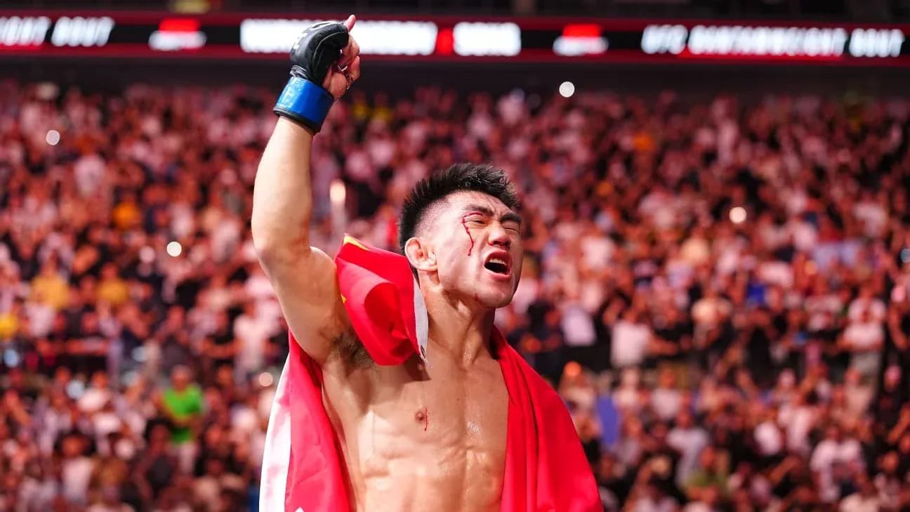 Fighter celebrating victory with a flag in crowd Fighter celebrating victory with a flag in crowd