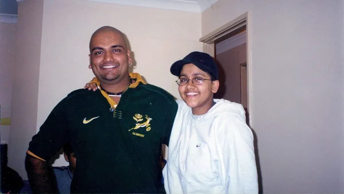 Two individuals smiling together indoors Two individuals smiling together indoors