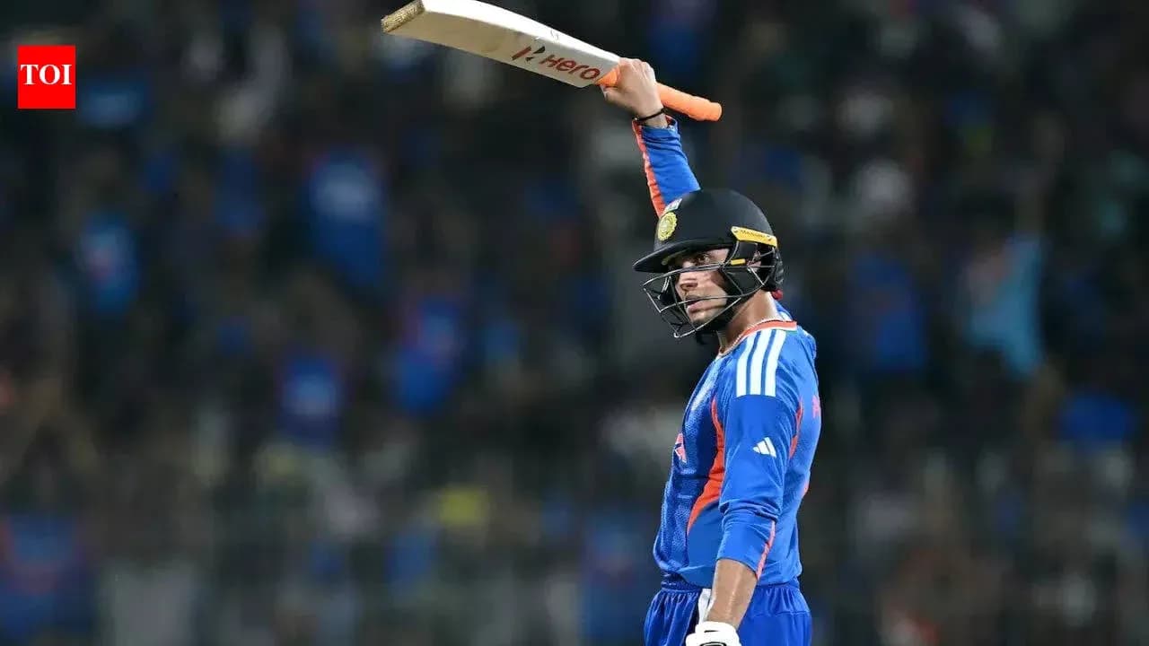 Cricketer celebrating with bat raised in stadium Cricketer celebrating with bat raised in stadium