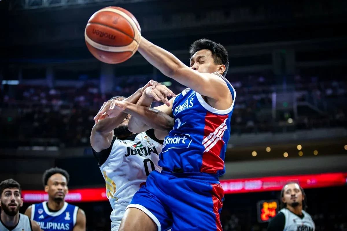 Player shooting the basketball while being defended Player shooting the basketball while being defended