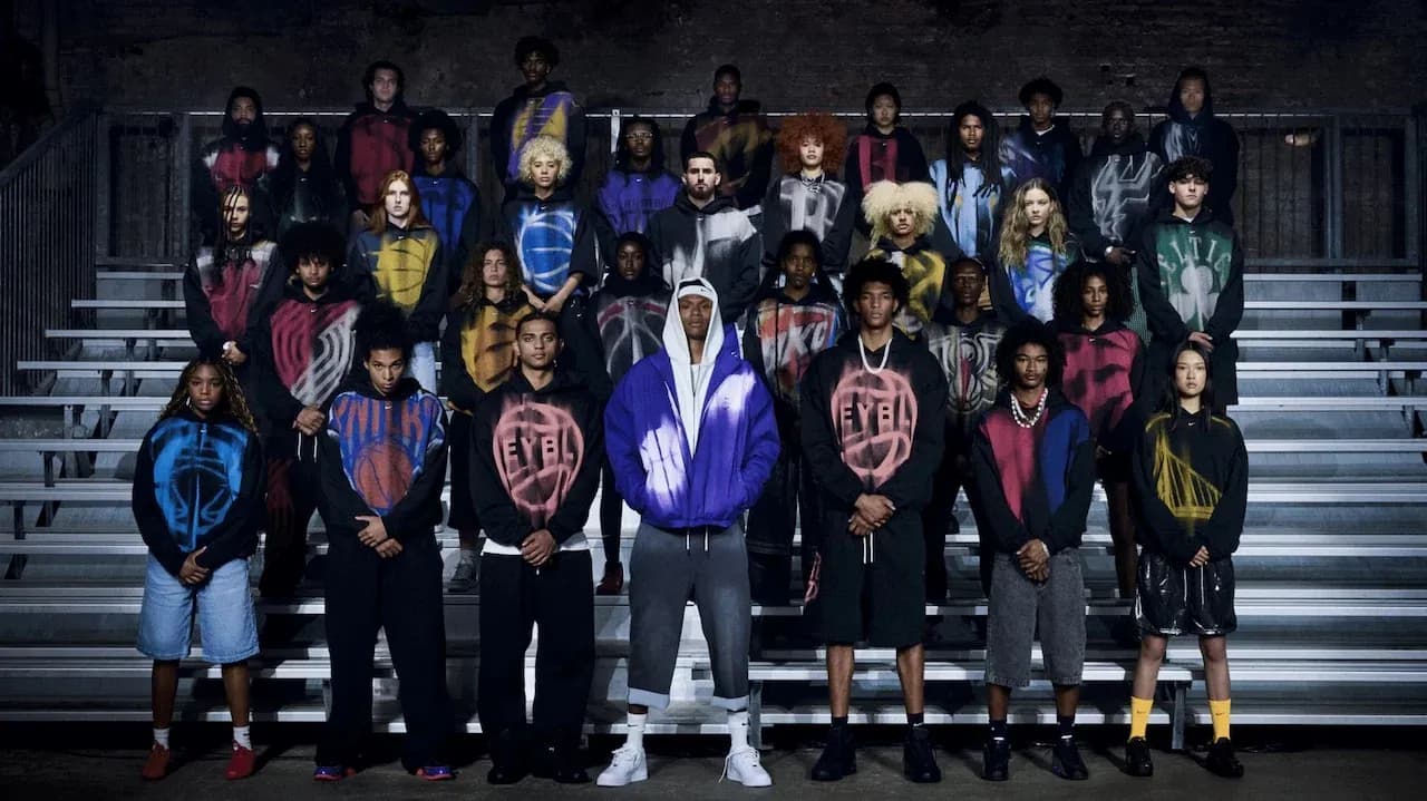 Group of individuals wearing colorful hoodies on bleachers Group of individuals wearing colorful hoodies on bleachers