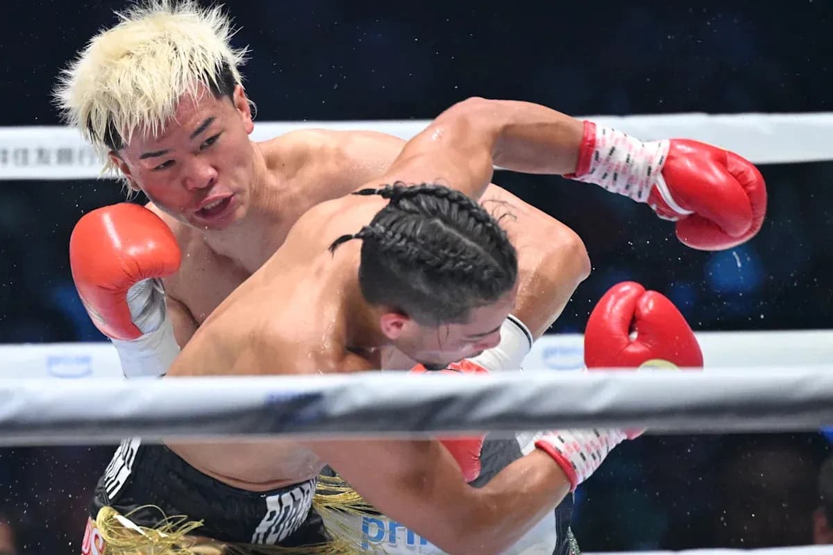 Boxer landing a punch during a match Boxer landing a punch during a match