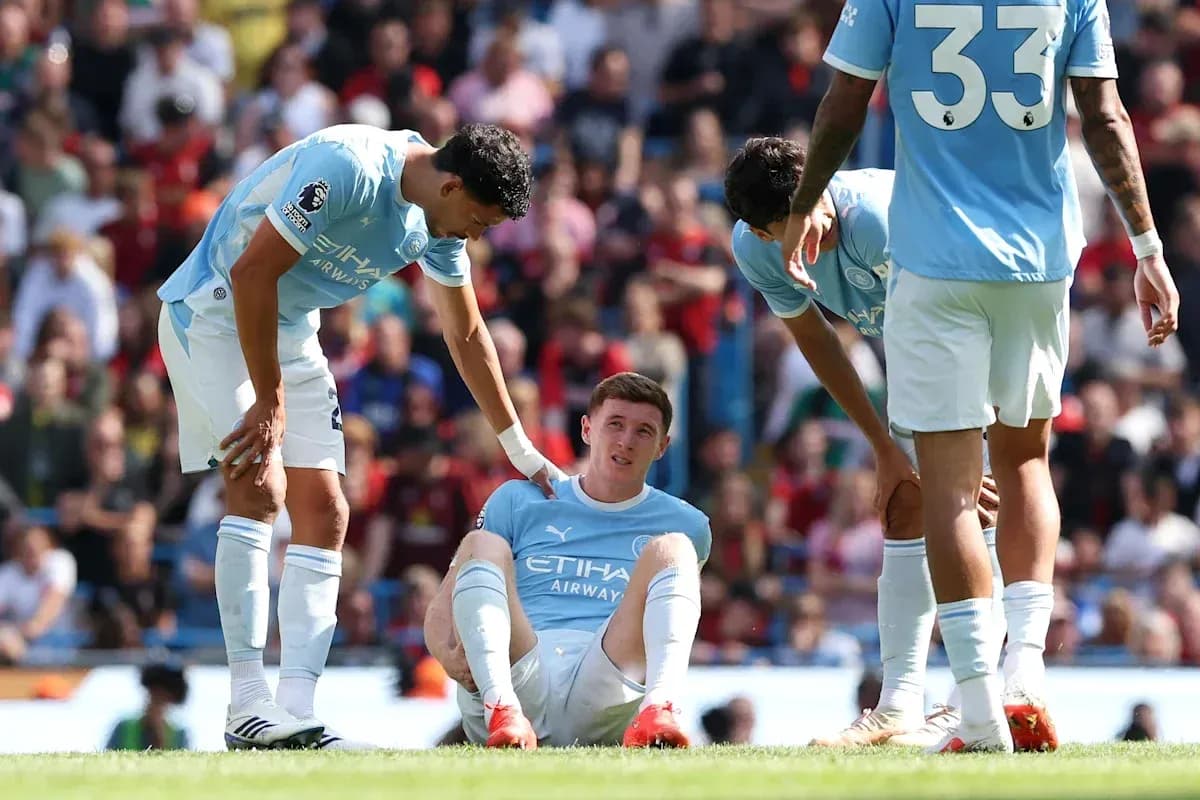 Player sitting on the ground with teammates assisting Player sitting on the ground with teammates assisting