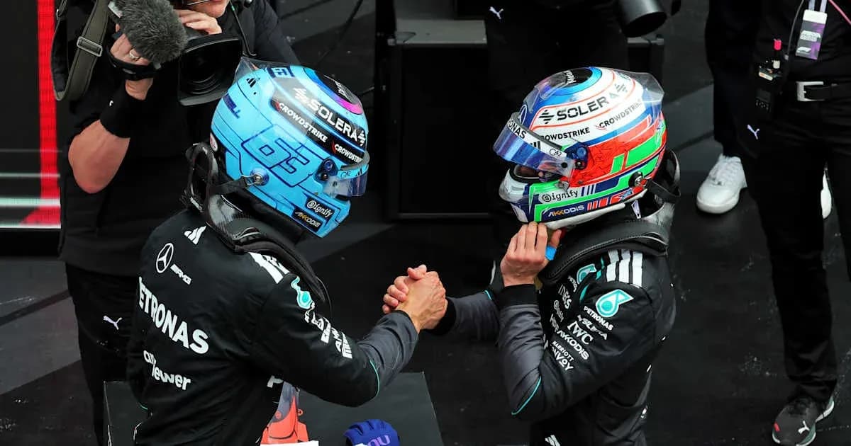 Two Formula 1 drivers shaking hands on podium Two Formula 1 drivers shaking hands on podium