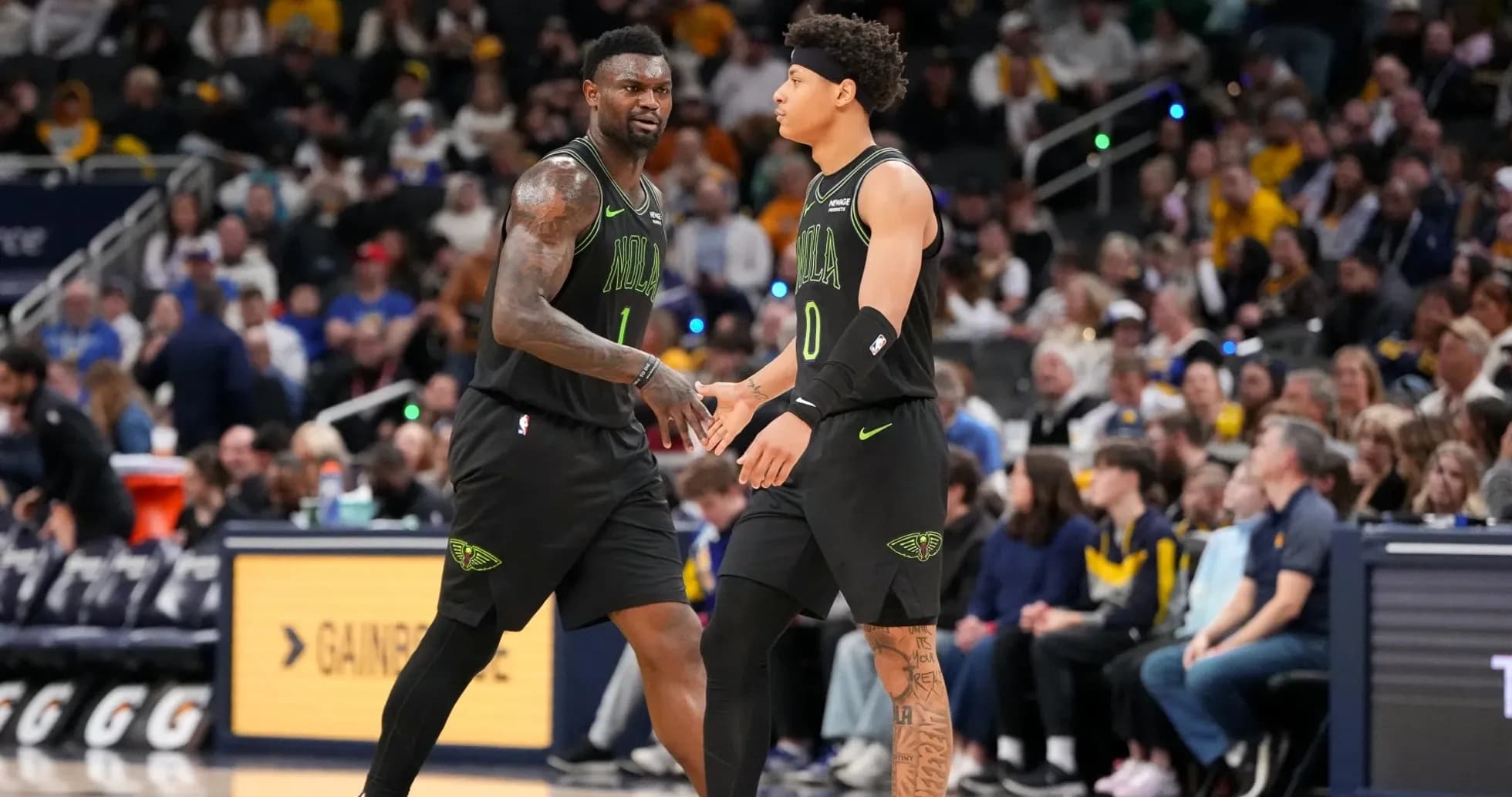 Two players from New Orleans Pelicans high-fiving during game Two players from New Orleans Pelicans high-fiving during game
