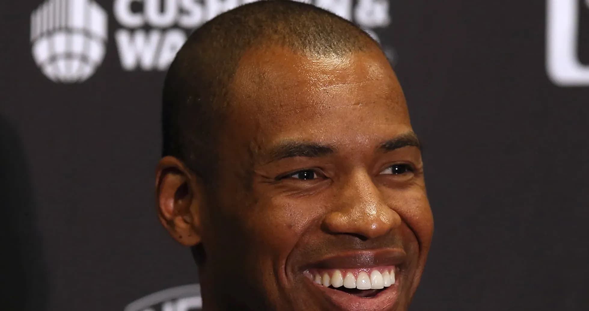 Smiling man at press conference backdrop Smiling man at press conference backdrop