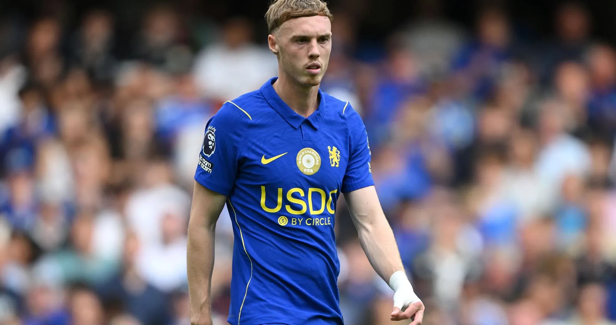 Player in blue Chelsea kit on the field Player in blue Chelsea kit on the field