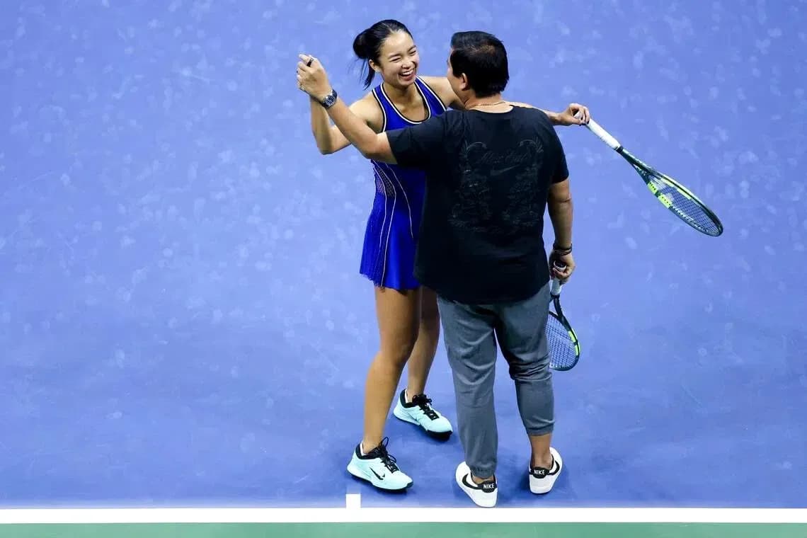 Player celebrating with coach on tennis court Player celebrating with coach on tennis court