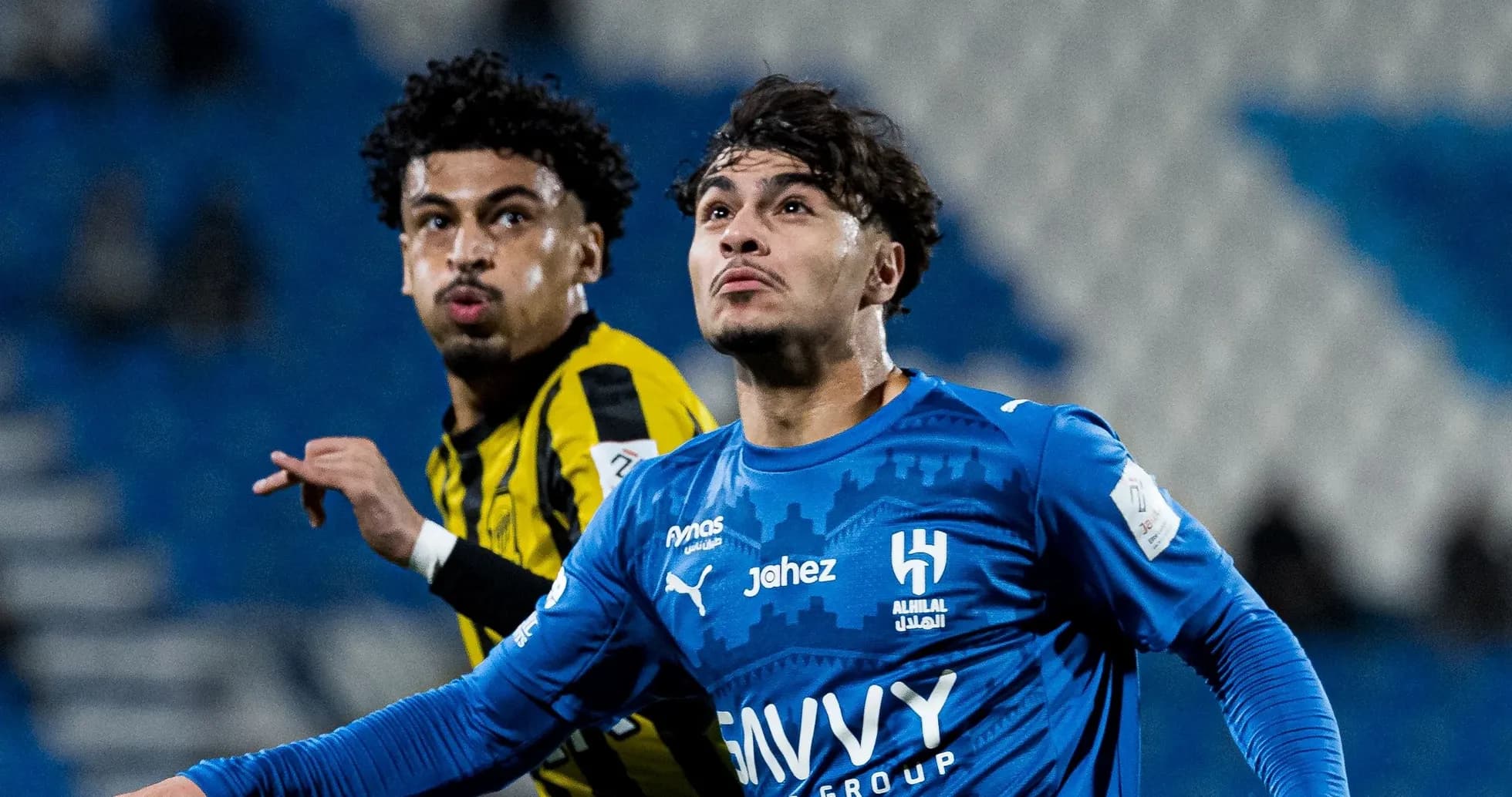 Two football players competing during a match Two football players competing during a match