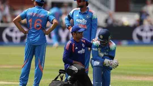 Player receiving treatment during cricket match on field Player receiving treatment during cricket match on field