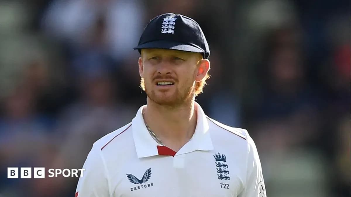 Cricketer wearing England kit and cap on field Cricketer wearing England kit and cap on field