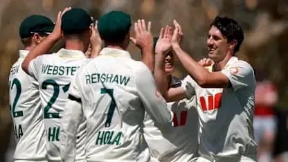Cricket team celebrating a wicket on field Cricket team celebrating a wicket on field