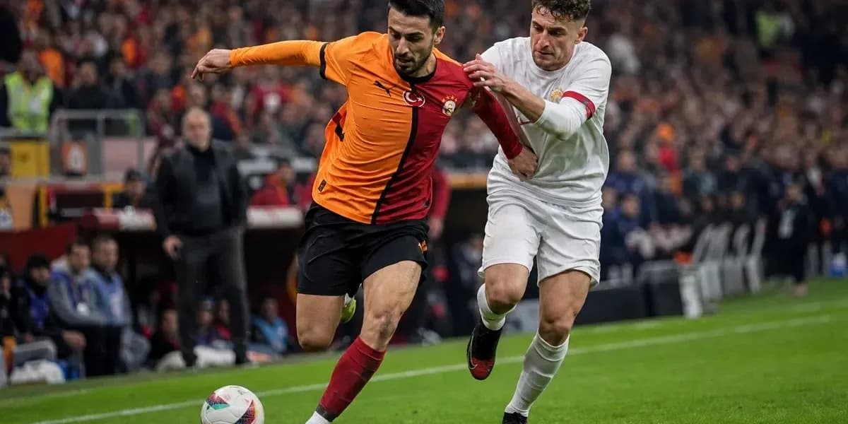 Player from Galatasaray evading opponent during match Player from Galatasaray evading opponent during match