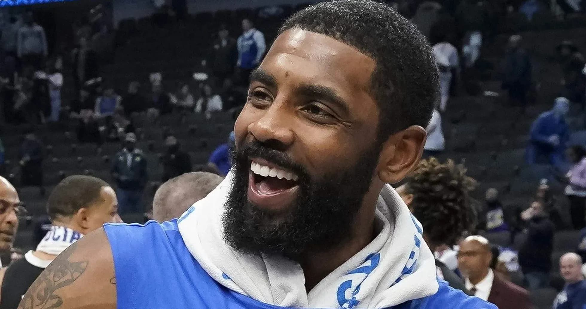 Player smiling after game, wearing blue jersey Player smiling after game, wearing blue jersey