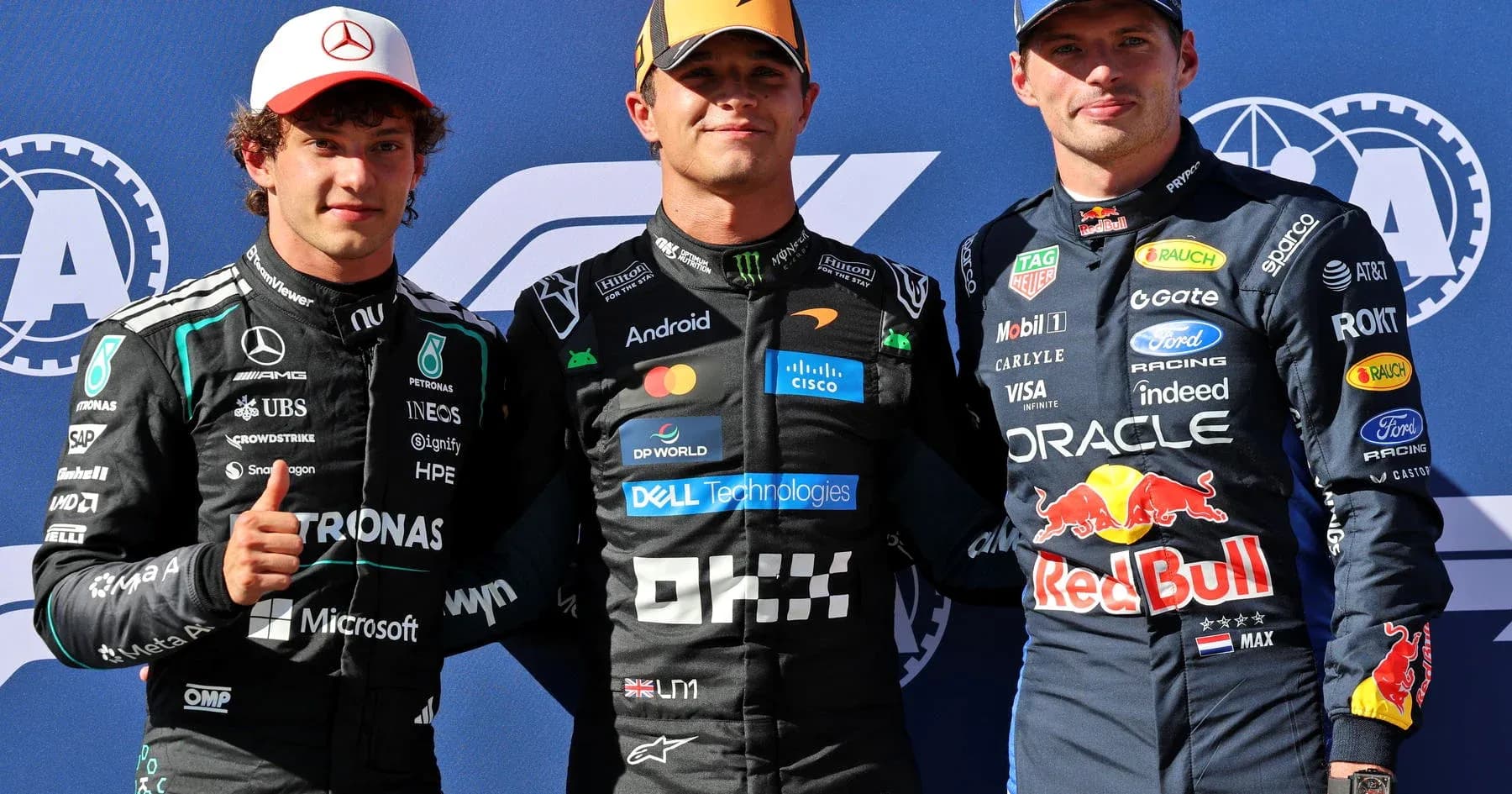 Three Formula 1 drivers posing at podium ceremony Three Formula 1 drivers posing at podium ceremony