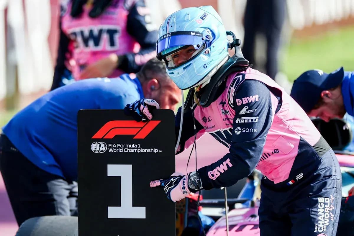 Driver holding first place sign during Formula 1 event Driver holding first place sign during Formula 1 event