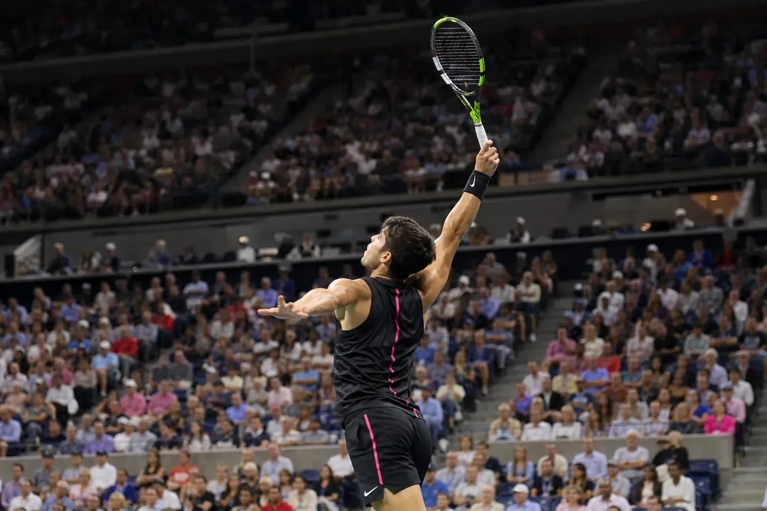 Tennis player serving during a match with crowd Tennis player serving during a match with crowd