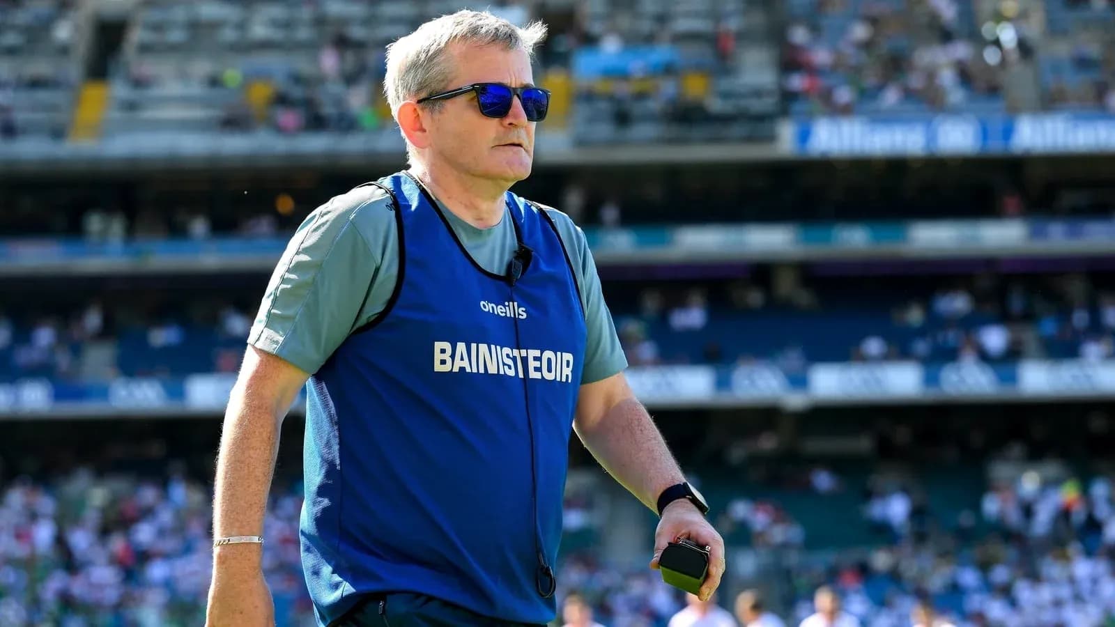 Coach walking on field during match warm-up Coach walking on field during match warm-up