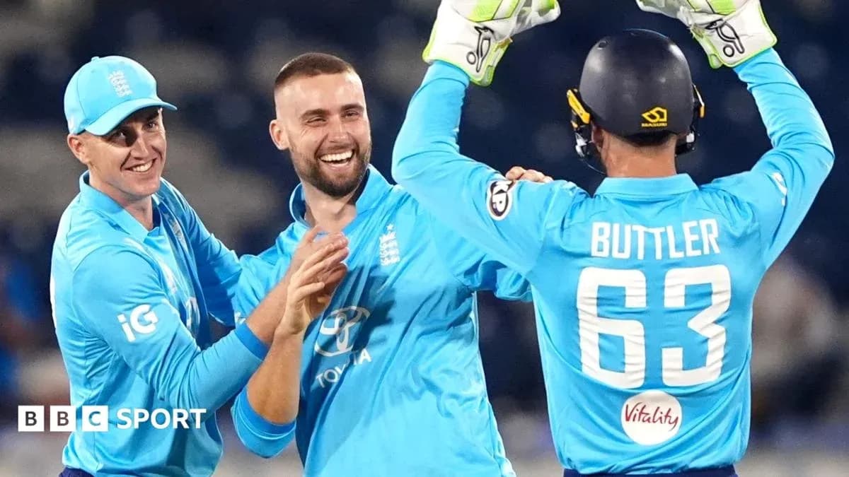 England cricketers celebrating a wicket on field England cricketers celebrating a wicket on field