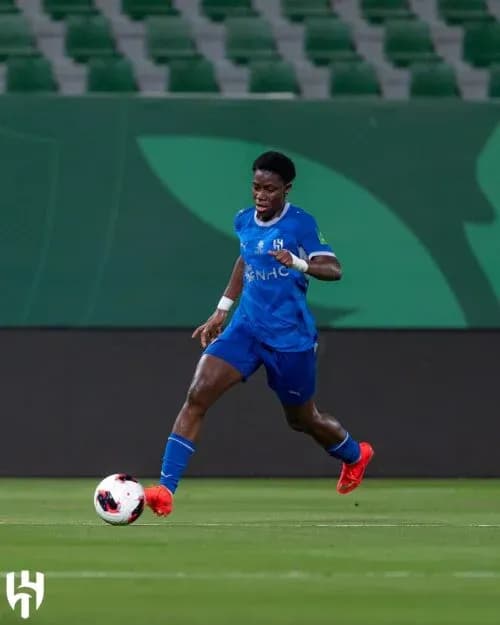 Player in blue kit dribbling the ball on field Player in blue kit dribbling the ball on field