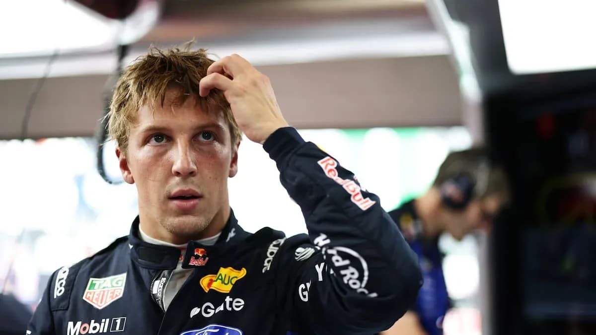 Driver adjusting hair in pit area before race Driver adjusting hair in pit area before race