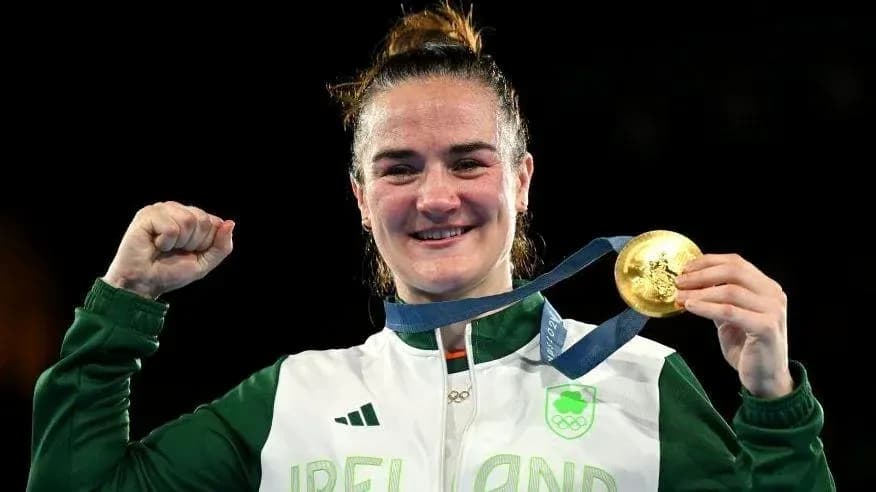 Athlete celebrating with gold medal at event Athlete celebrating with gold medal at event