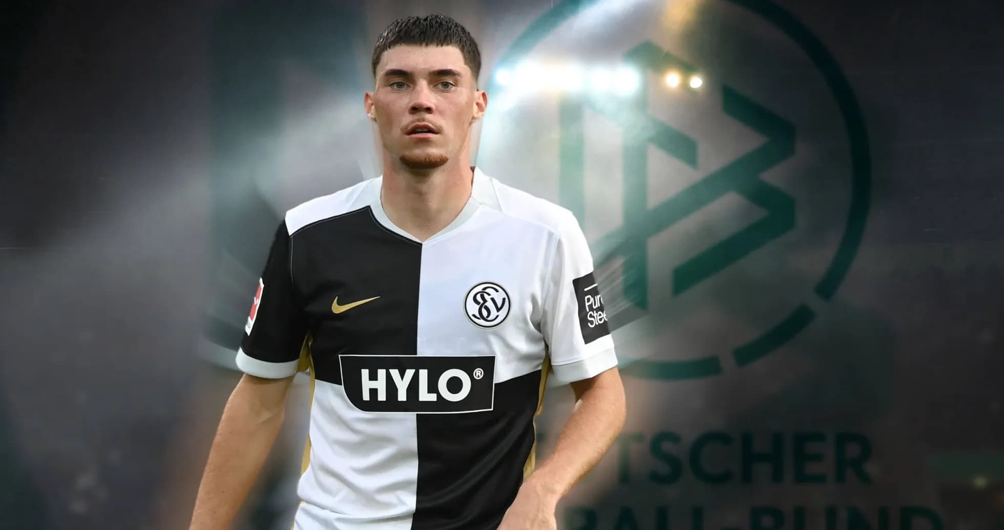 Player in black and white jersey on pitch Player in black and white jersey on pitch