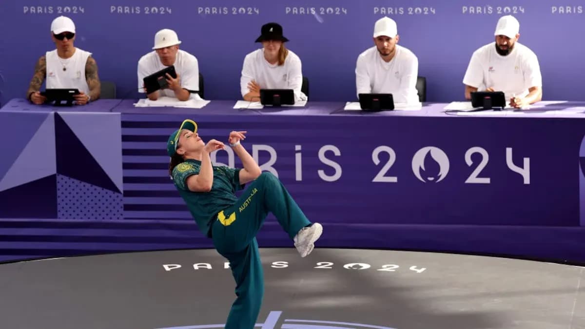 Athlete performing at Paris 2024 event with judges Athlete performing at Paris 2024 event with judges