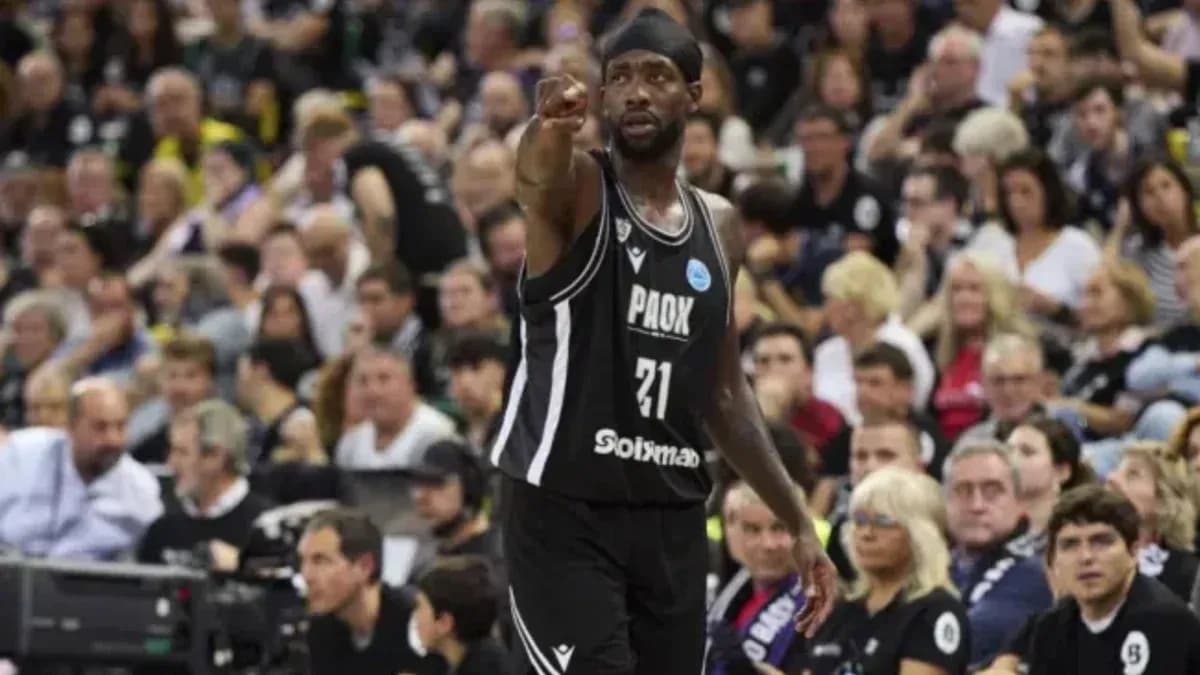 Player signaling during basketball game with crowd behind Player signaling during basketball game with crowd behind