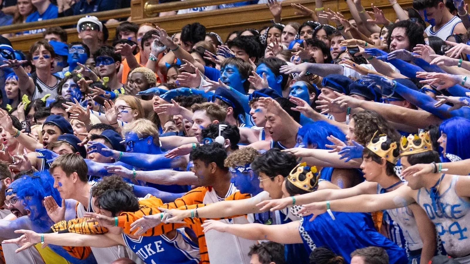 Duke fans cheering with blue face paint and costumes Duke fans cheering with blue face paint and costumes