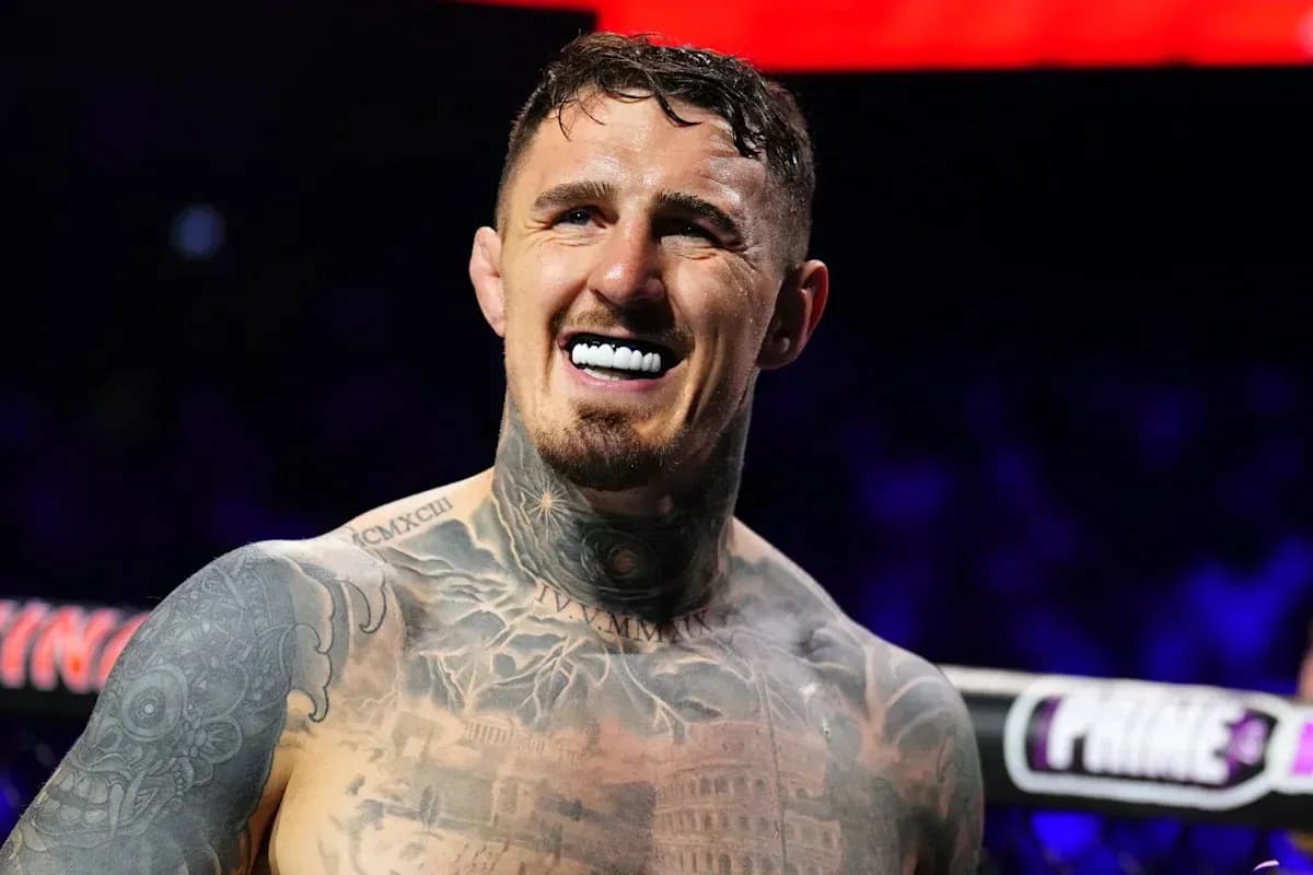 Boxer smiling with tattoos and mouthguard in ring Boxer smiling with tattoos and mouthguard in ring