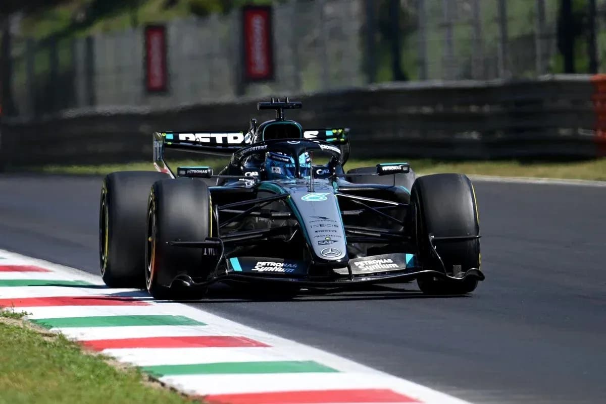 Formula 1 car navigating a turn on the track Formula 1 car navigating a turn on the track
