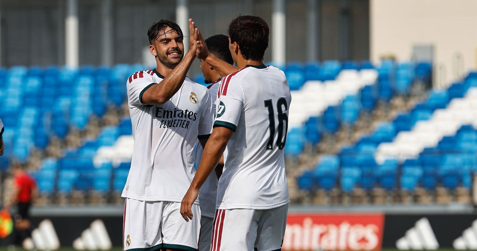 Real Madrid players celebrating a goal on the pitch Real Madrid players celebrating a goal on the pitch