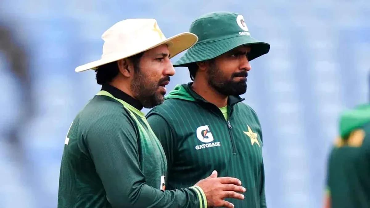 Two cricketers in training gear discussing together Two cricketers in training gear discussing together