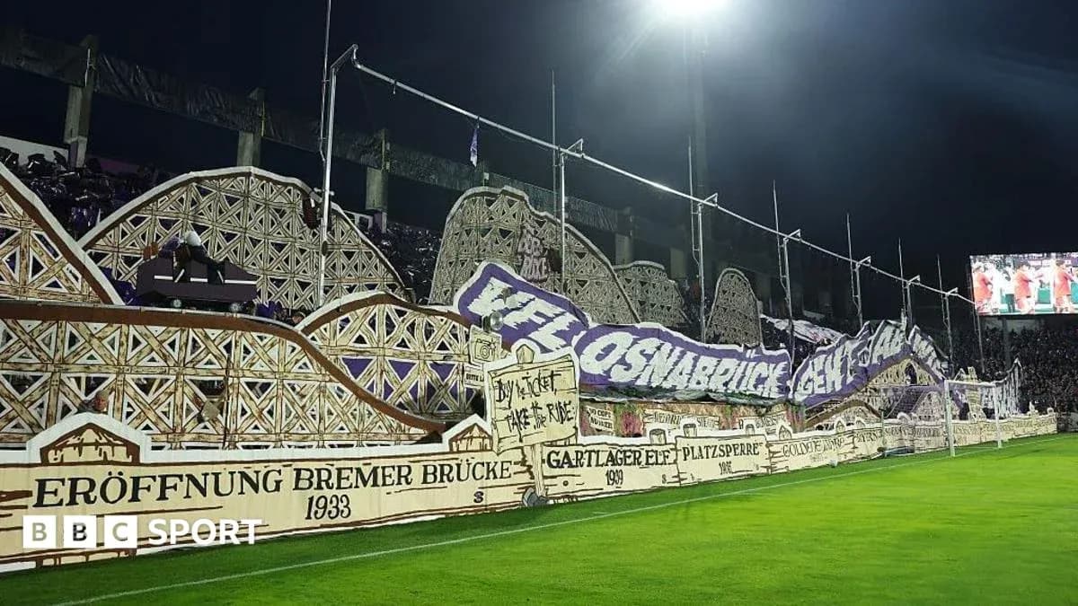 Fan banners displayed in stadium during match Fan banners displayed in stadium during match