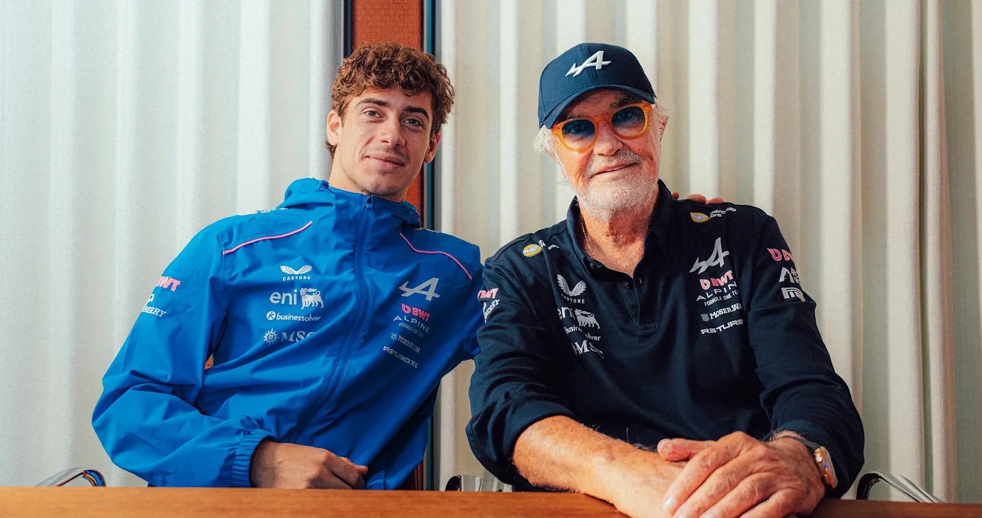Two men posing together at a table Two men posing together at a table