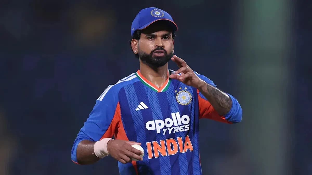 Cricketer gesturing while holding a ball on field Cricketer gesturing while holding a ball on field