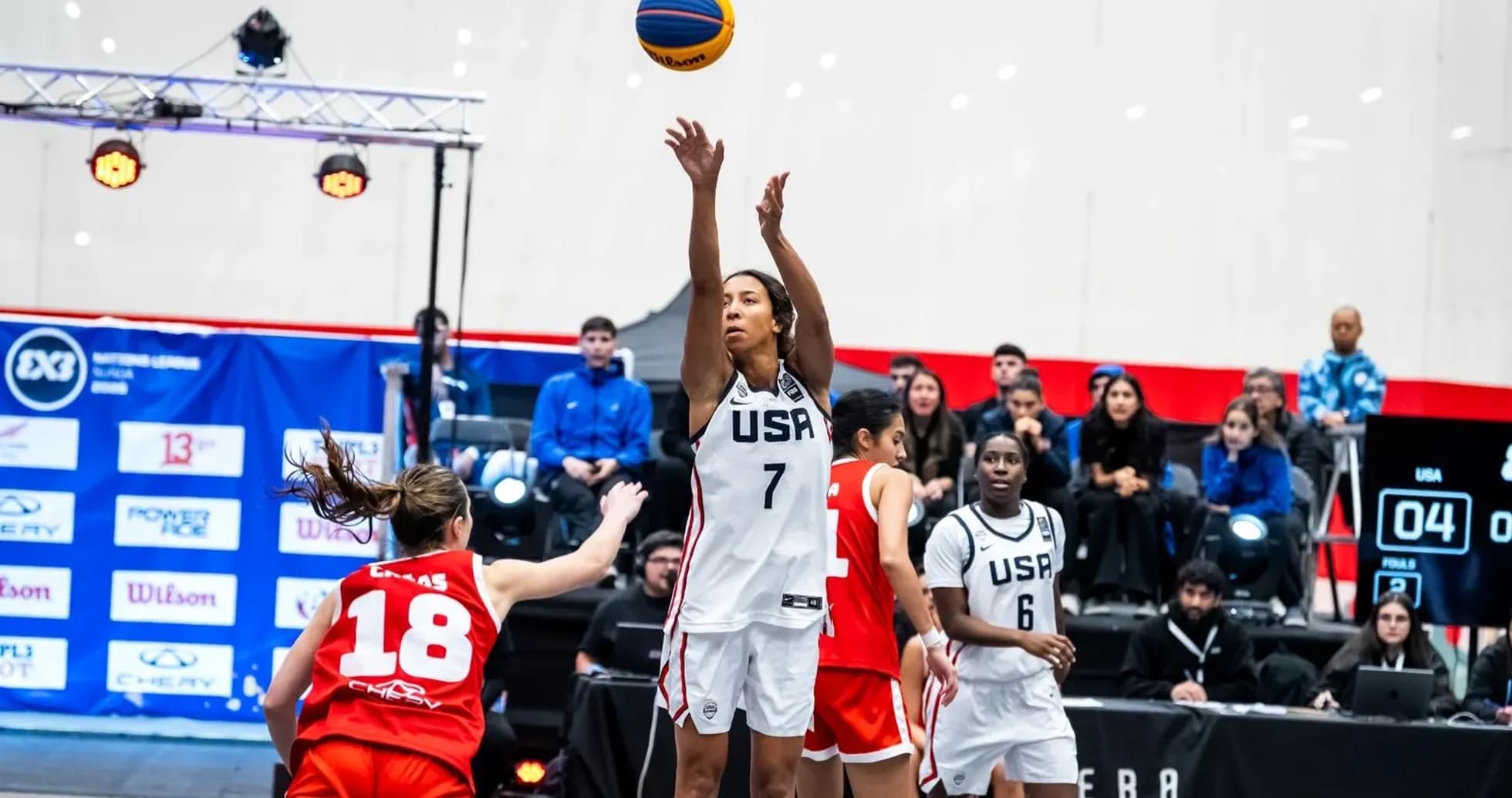 Player shooting a basketball during a game Player shooting a basketball during a game
