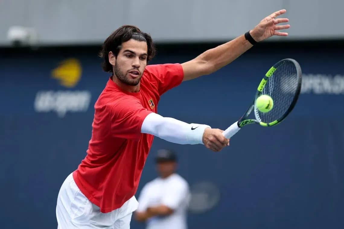 Player hitting a forehand during tennis practice Player hitting a forehand during tennis practice