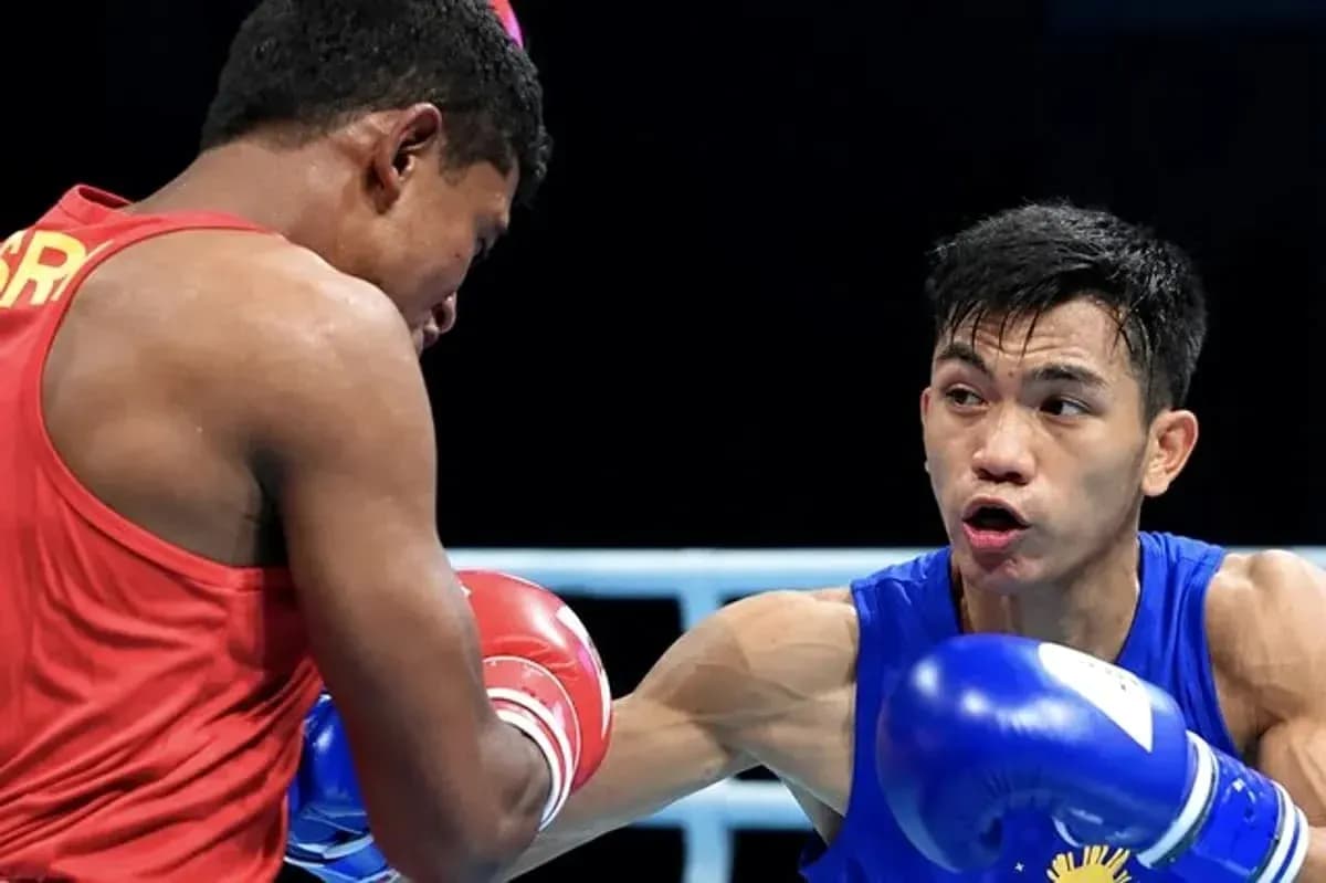 Two boxers competing in a match, one in blue Two boxers competing in a match, one in blue