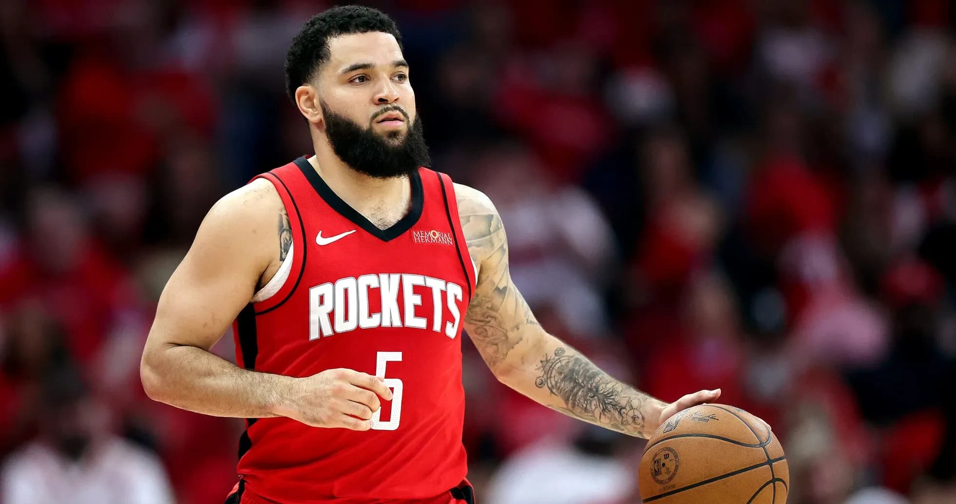 Player dribbling basketball in Houston Rockets uniform Player dribbling basketball in Houston Rockets uniform