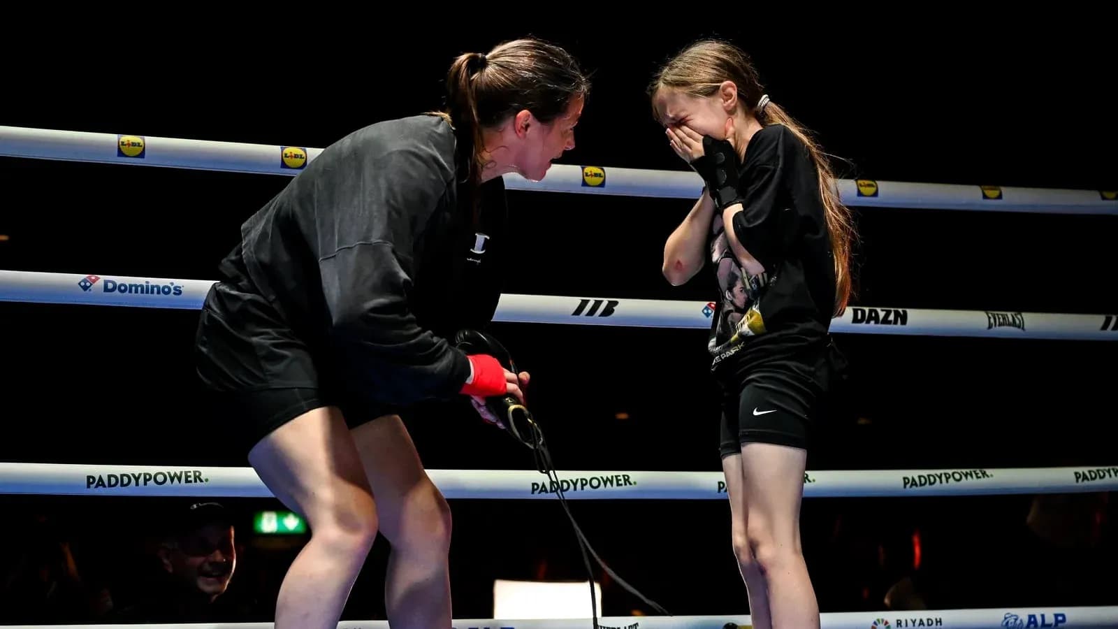 Boxer interacting with young girl in ring Boxer interacting with young girl in ring