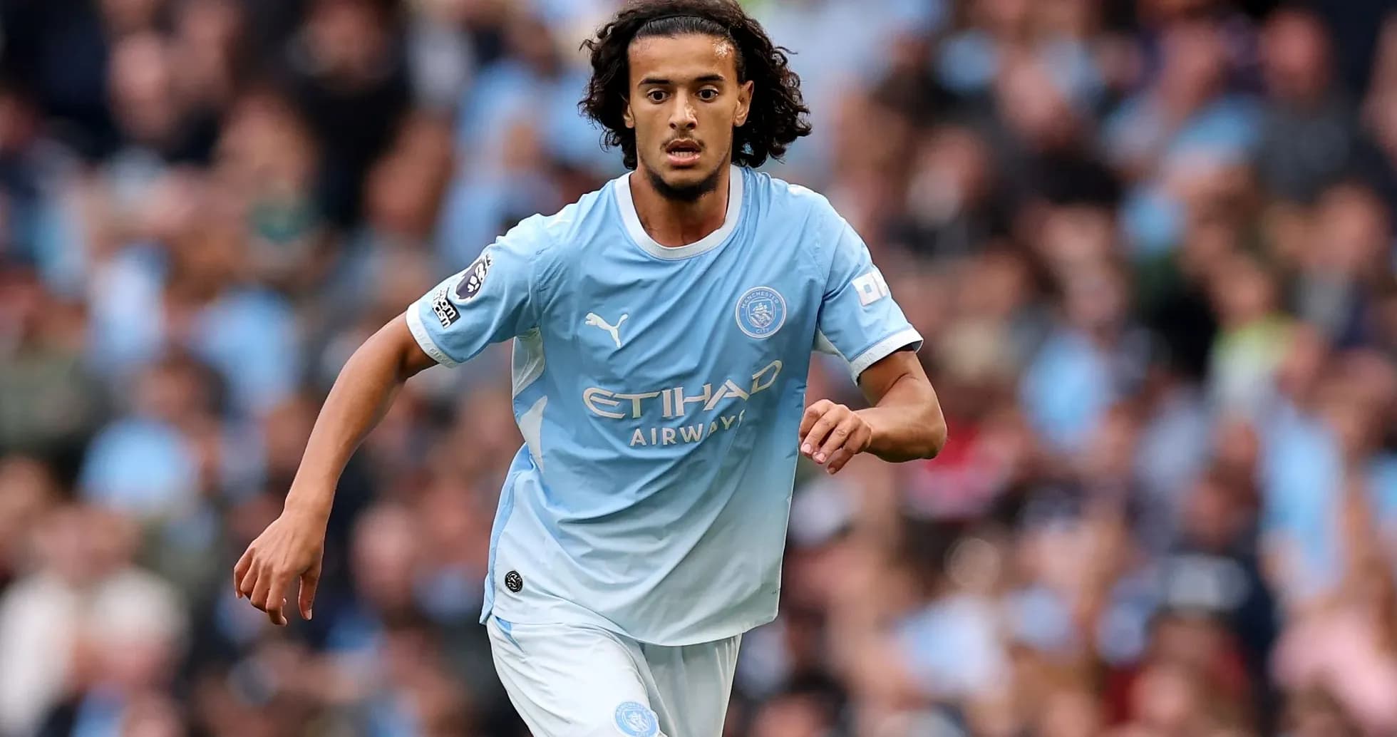 Player running on the field in Manchester City kit Player running on the field in Manchester City kit