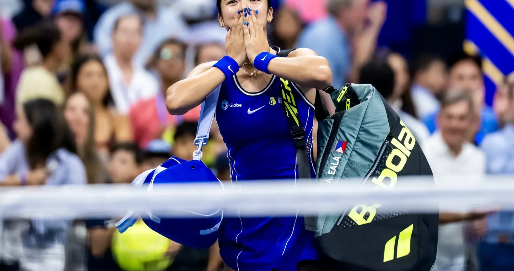 Tennis player celebrating after match with bags Tennis player celebrating after match with bags