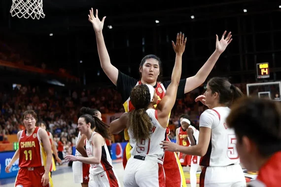 Players competing during a basketball game action Players competing during a basketball game action